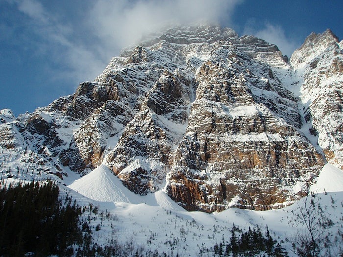 Mt. Chephren’s mile-high east fac Mt. Chephren’s mile-high east face. The Dogleg Couloir starts up the obvious snow gully on the right. At about half-height, it branches left…