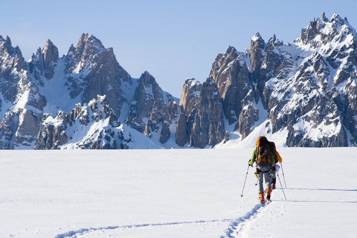 Andrew Wexler (leading) and Dylan Taylo Andrew Wexler (leading) and Dylan Taylor reaching a 4,500-foot pass between the Capps and Triumvirate glaciers. The towers ahead rise above the…