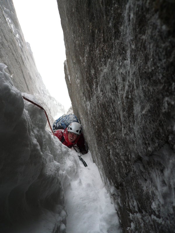 Zack Smith squeezes through the chimney Zack Smith squeezes through the chimneys of The Message or the Money (M6) on Kichatna Spire. Courtesy of Josh Wharton -…