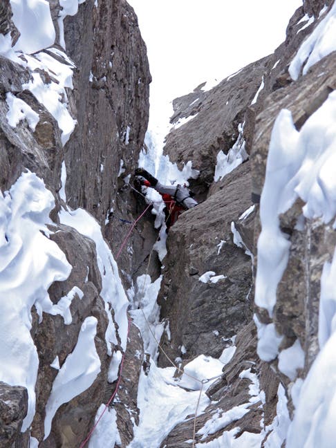 Jon Simms free-climbing the crux M7 overhang (formerly A3) on The Wild Thing, east face of Mt. Chephren in the Canadian Rockies. Photo by Jon Walsh.
