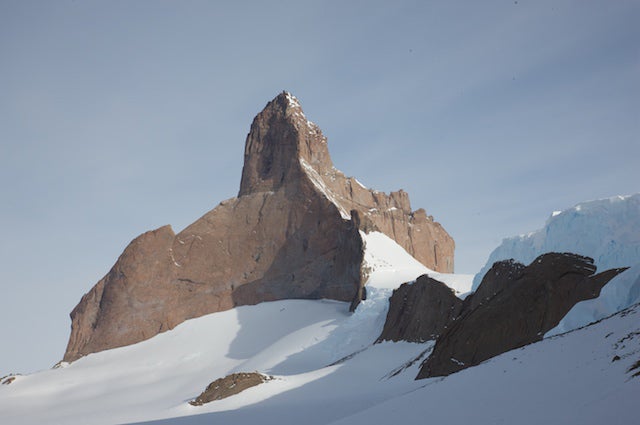 The extraordinary Ulvetanna (“Wol The extraordinary Ulvetanna (“Wolf’s Tooth), with the northwest buttress (Sound of Silence, 800m, 5.11- A2 60°) facing the camera in…