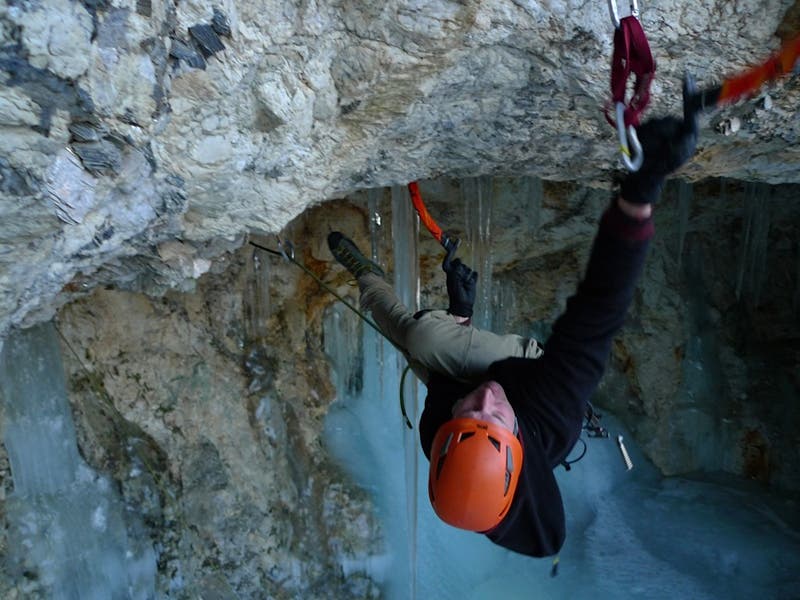Bayard Russell trying to make the span Bayard Russell trying to make the span on the crux of John Henry (M10/11) at the Mica Mine cave in Evans Notch. Photo by Freddie Wilkinson.