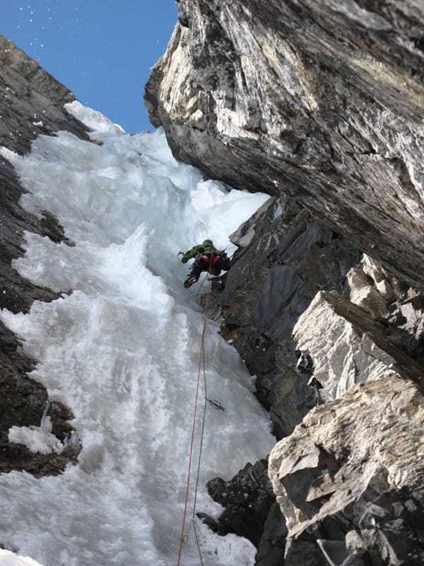 Jay Smith leading the beautiful fifth p Jay Smith leading the beautiful fifth pitch (WI5+) of The Black Pearl on the Scottish Wall, south of Mt. Huntington. Photo by Jack Tackle.