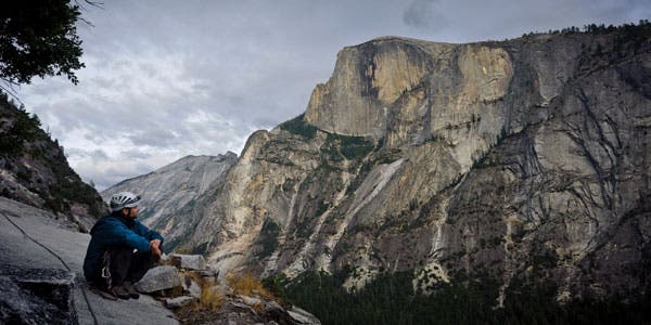 NW-Face-Half-Dome-BW_34936 Climber looks out to Yosemite Valley after climbing a big wall.