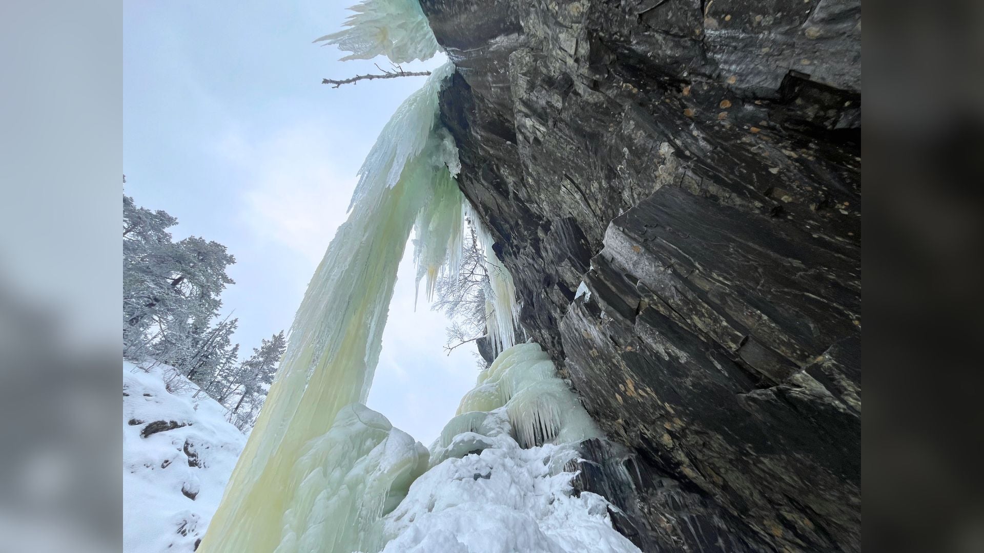 A narrow pillar of ice in Norway that must be assessed carefully before climbing.