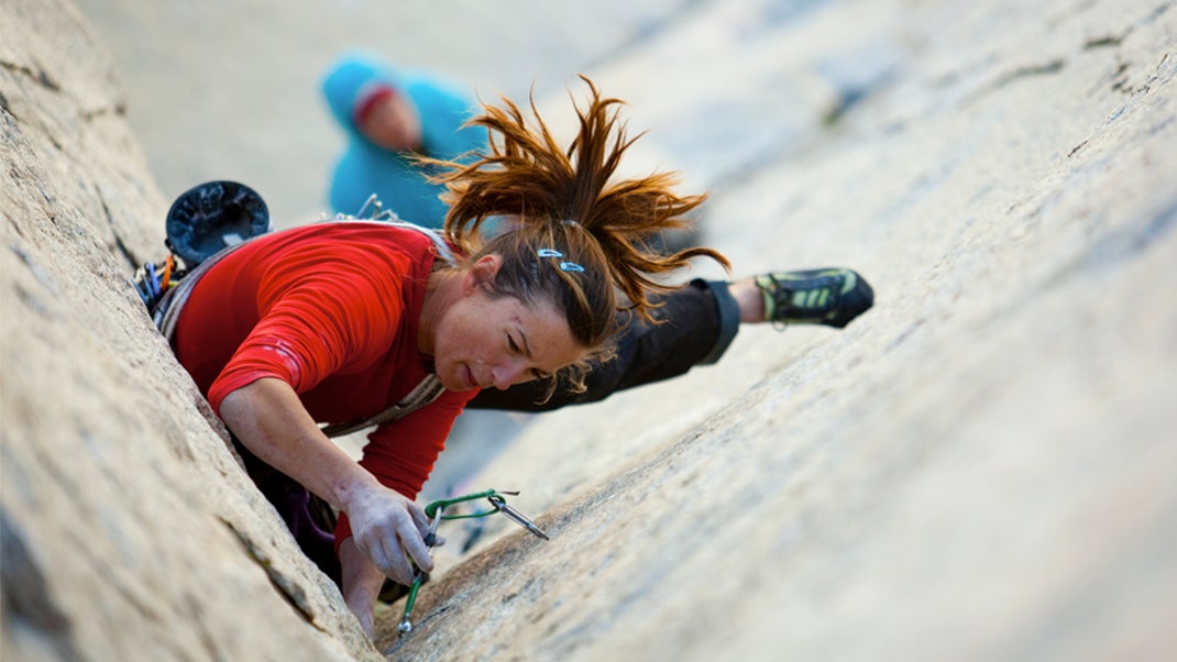 Trad climber placing gear