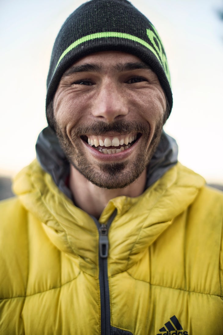 portrait_Kevin Jorgeson_(c)BlighGillies Kevin Jorgeson smiles in a close up shot while wearing a black beanie and yellow jacket.