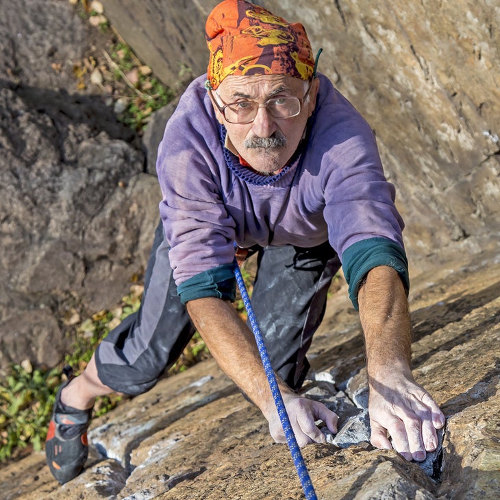 shutterstock_231975178 copy old man rock climbing crusty trad toprope follow
