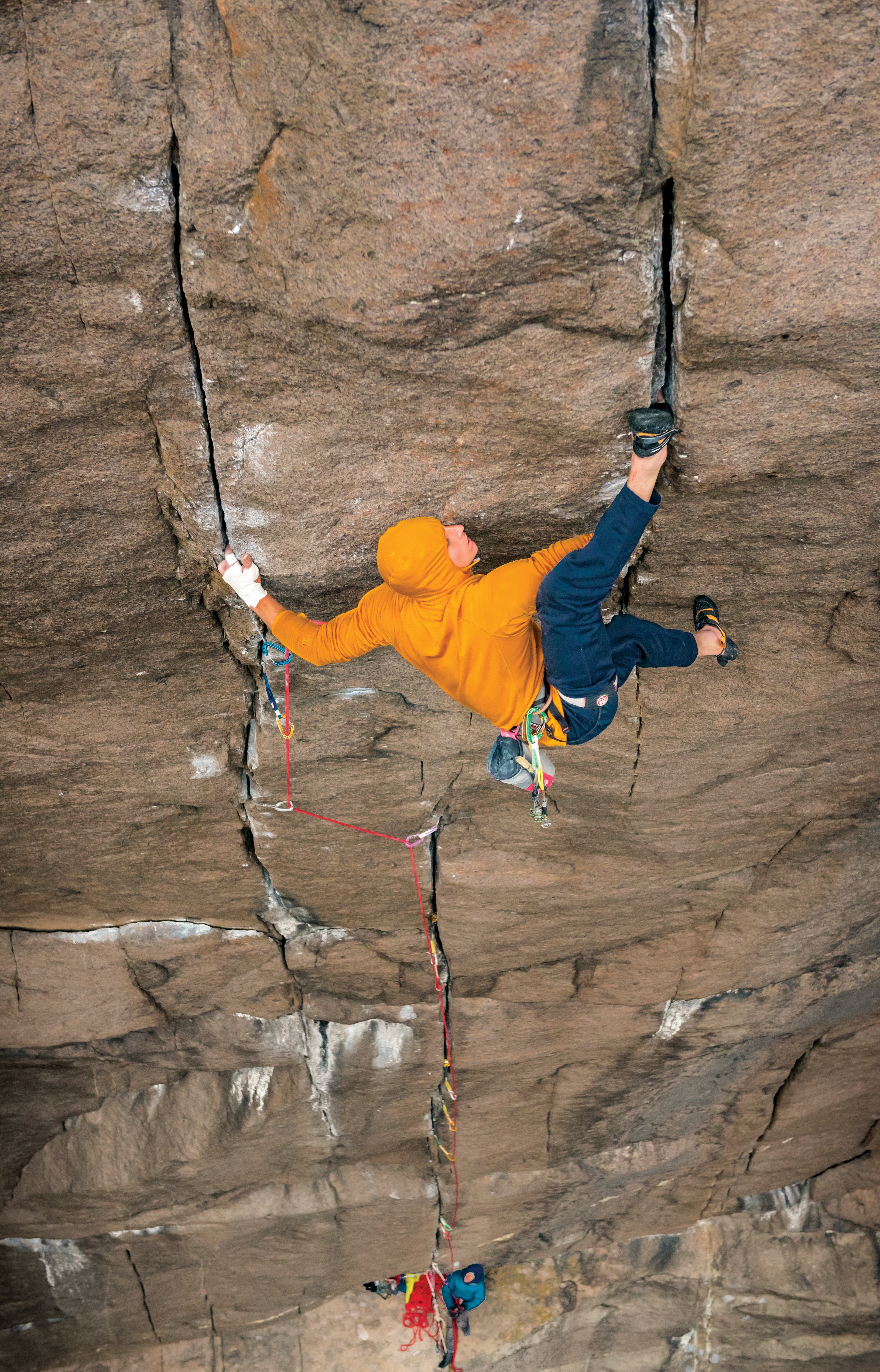 TristanHobson_7874_gn-web Man fitting his heel up above his head into a crack