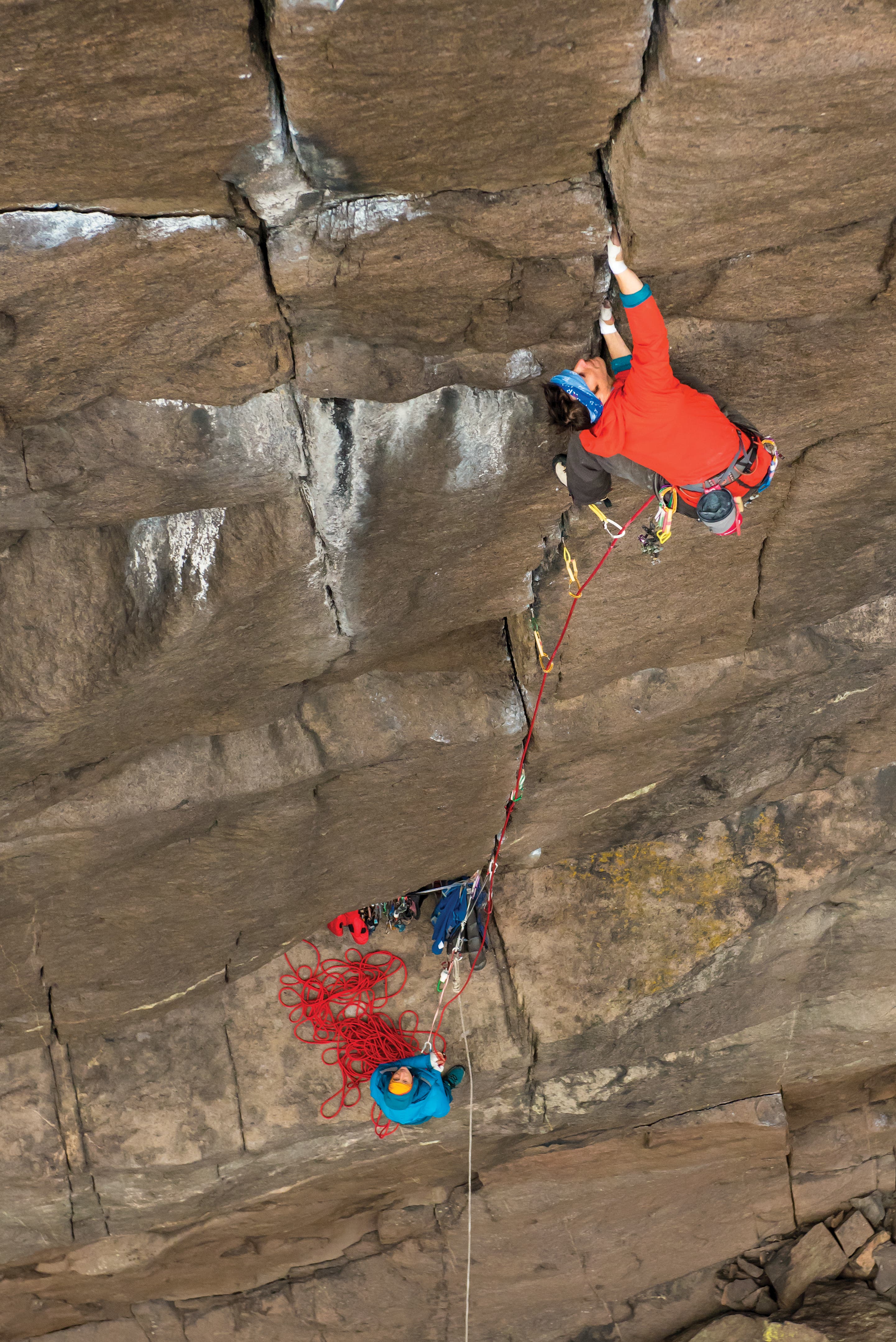TristanHobson_8034_gn-web Man climbing while belayer watches on