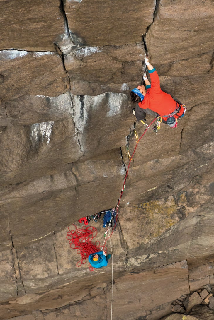 TristanHobson_8034_gn-web Man climbing while belayer watches on
