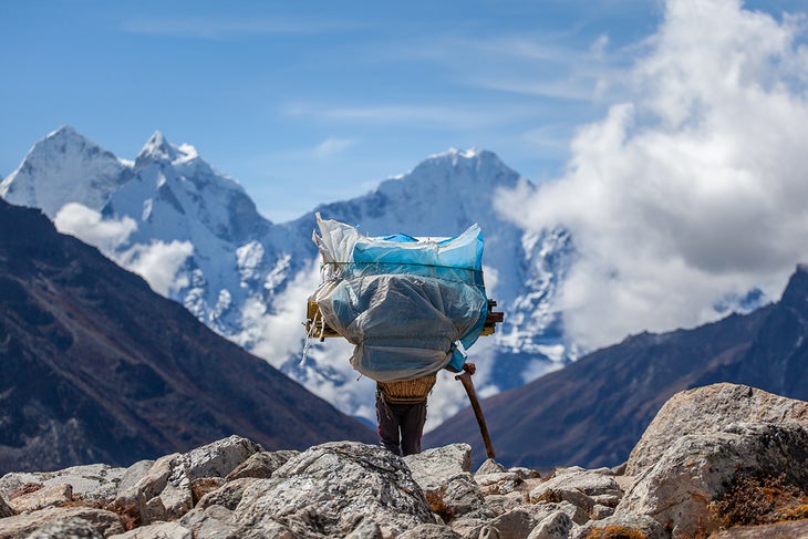 1560512426-huge A porter carrying a heavy load on the trek to Everest Base Camp.