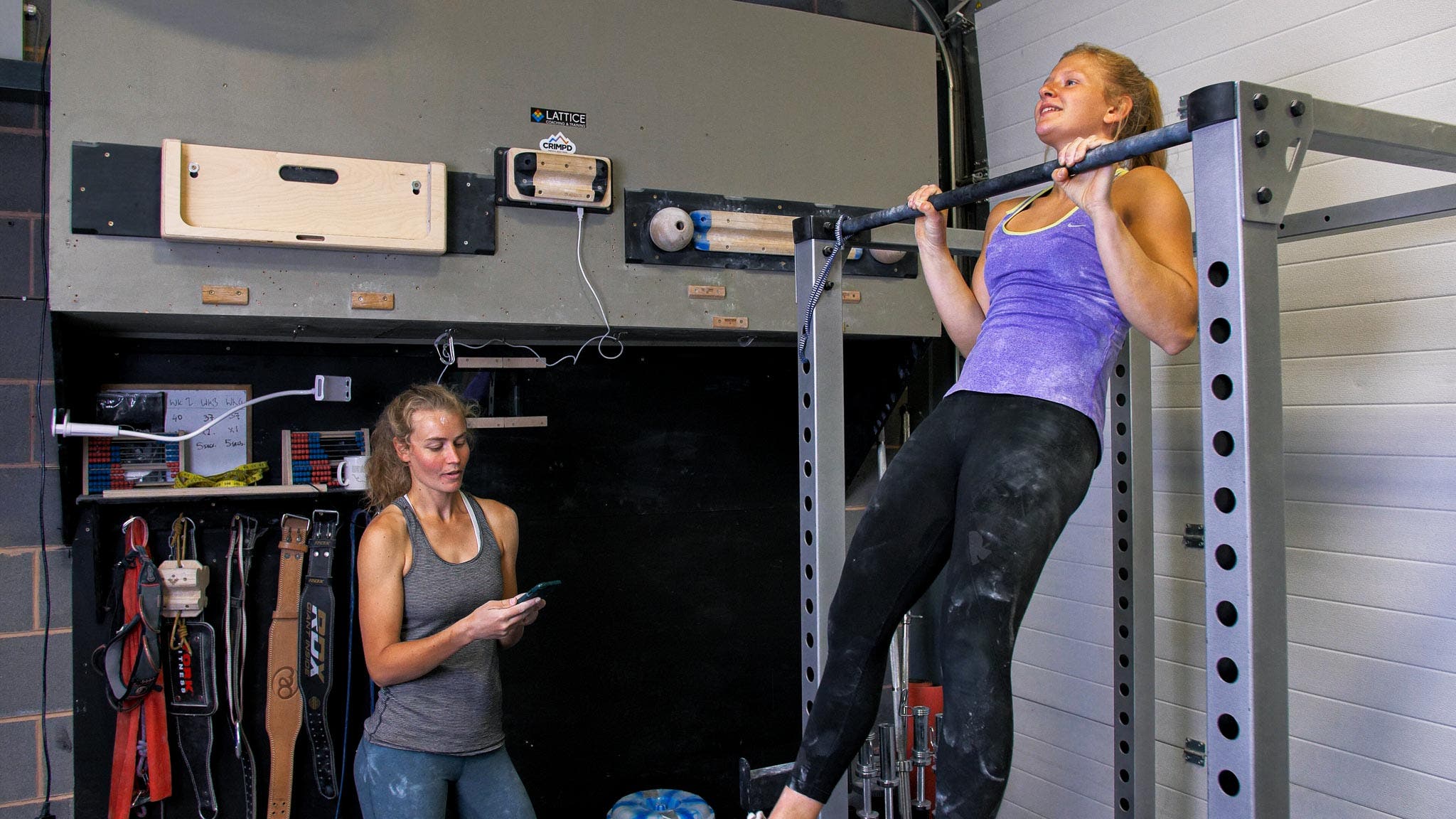 two women do pull ups as part of their climbing training 