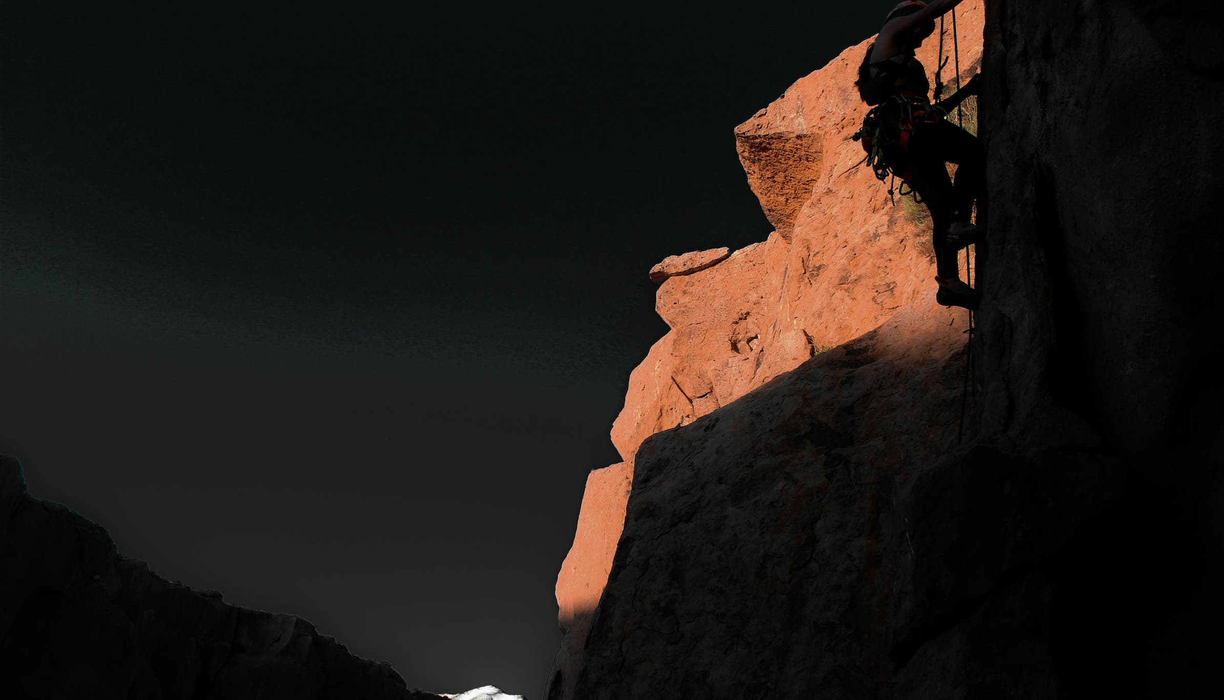 survive an unplanned night in the mountains: a climber climbing at night