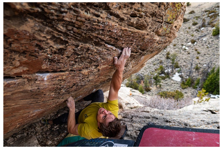 A climber doing a hard deadpoint.