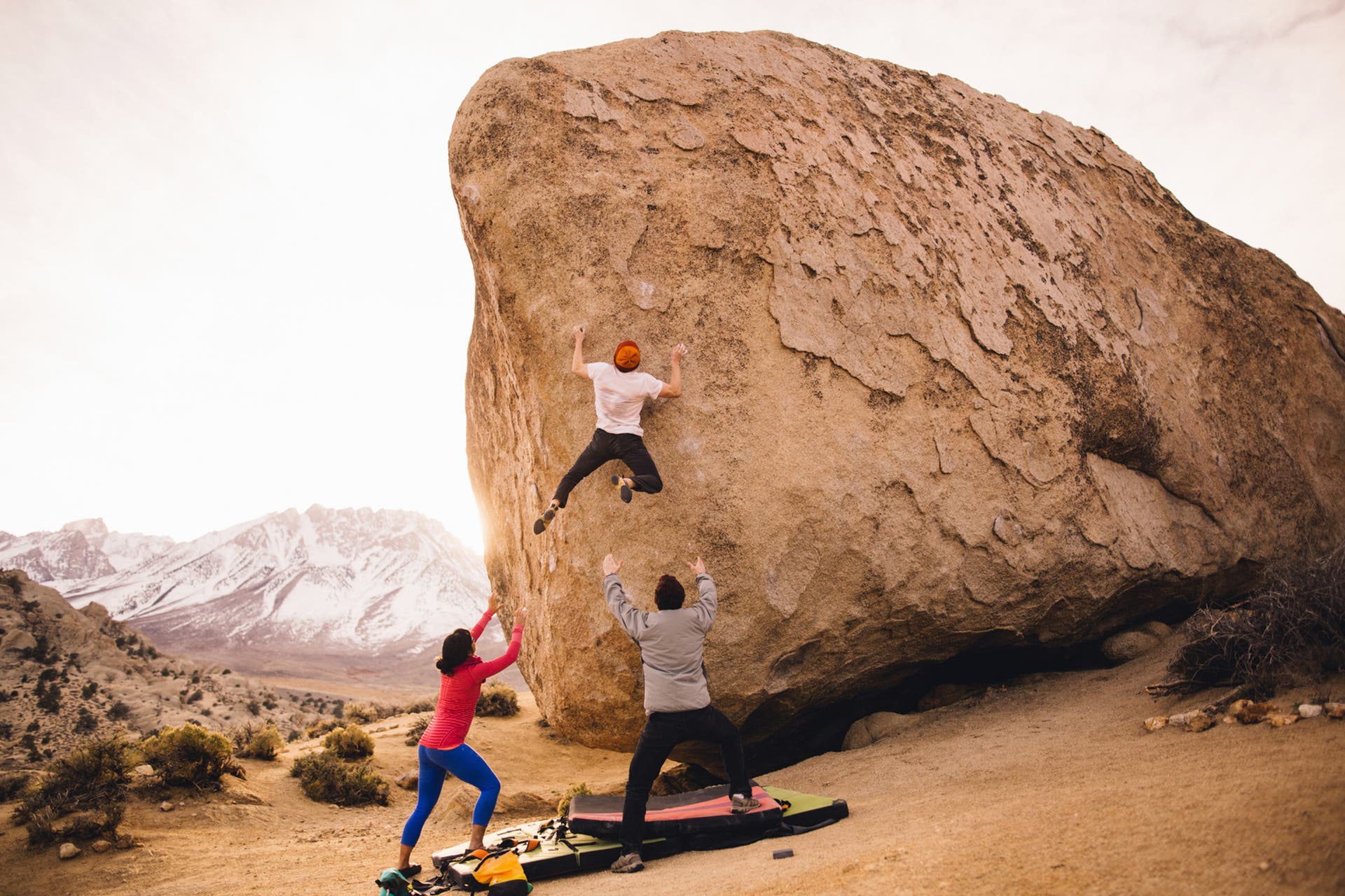 Group climbs at an outdoor boulder.