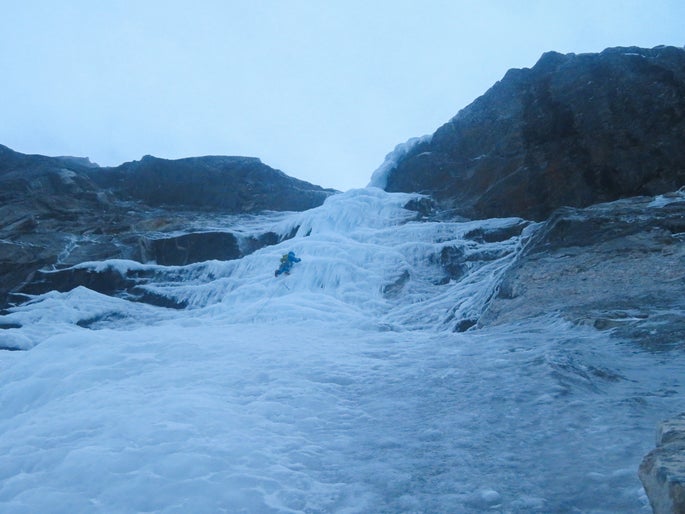 Man climbs ice in Norway.