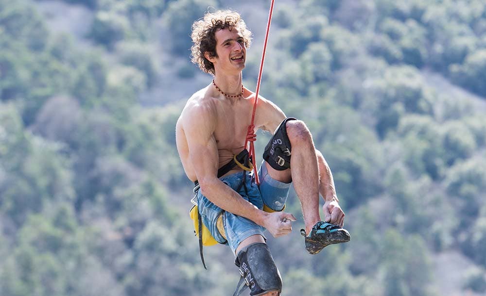 Rock climber Adam Ondra lowering from a climb.