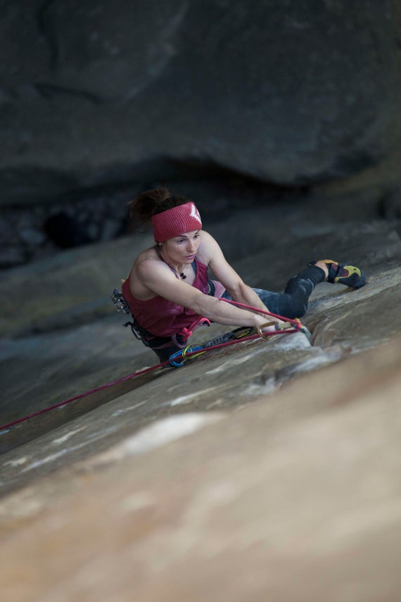 Woman rock climbs in France.