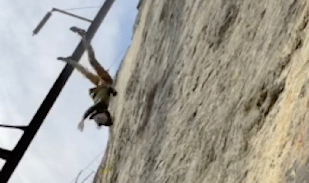 Man falls rock climbing.