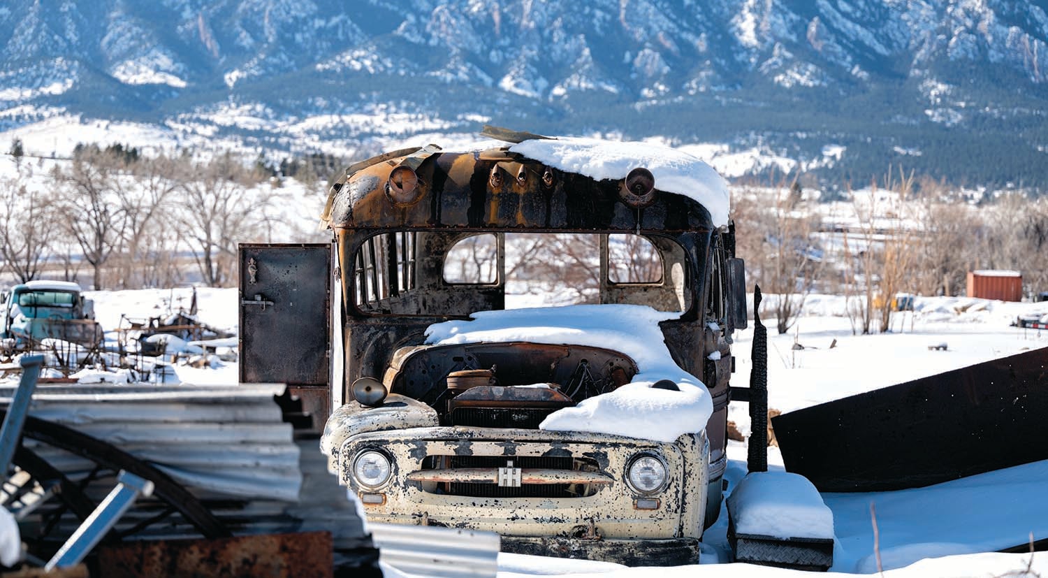 The school bus where Earl Wiggins, Katy Cassidy, and others lived, with the Flatirons visible in the background.