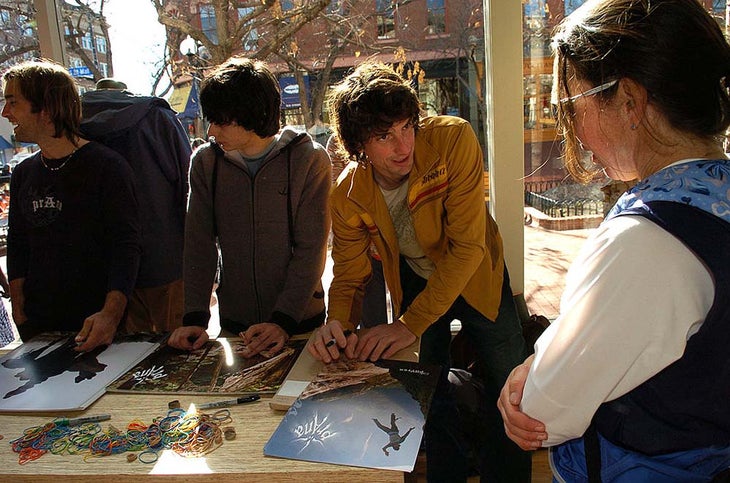 Dean Potter signing a poster for a fan at a store opening in Denver.