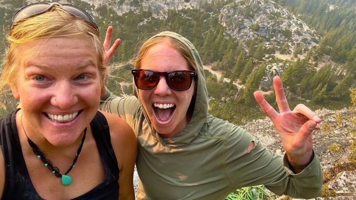 Two women standing on a mountain