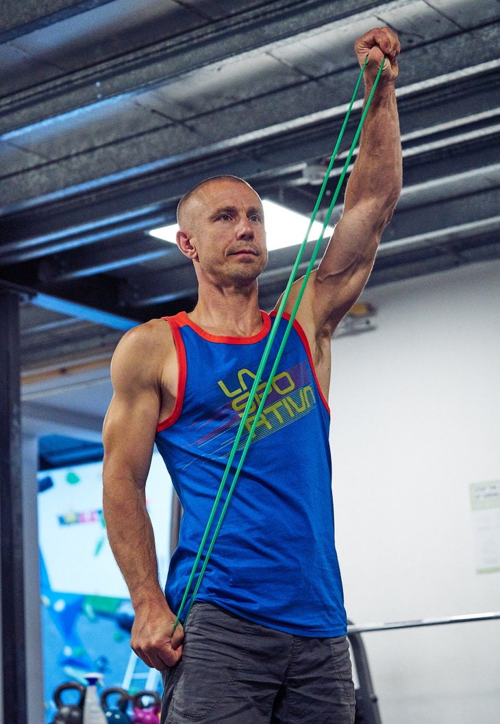 Climber warming up using stretch bands.