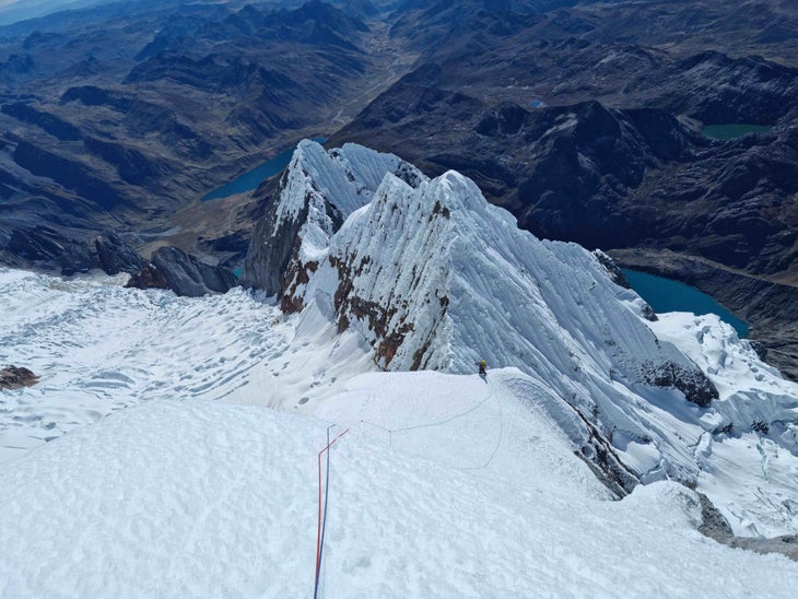 A snowy ridge high on the East Face of Siula Grande, Peru.