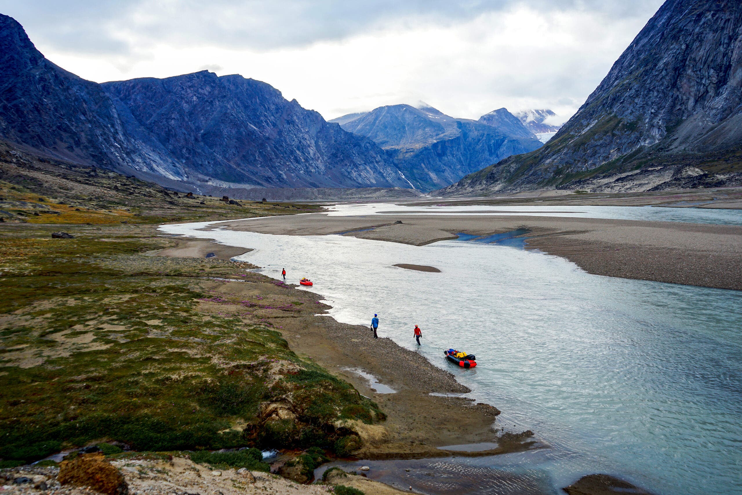 Expedition climbers haul gear-laden rafts on Baffin Island