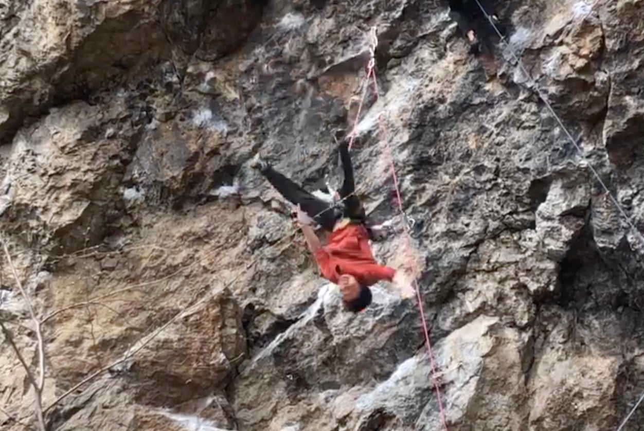 Climber catches leg behind rope and falls.