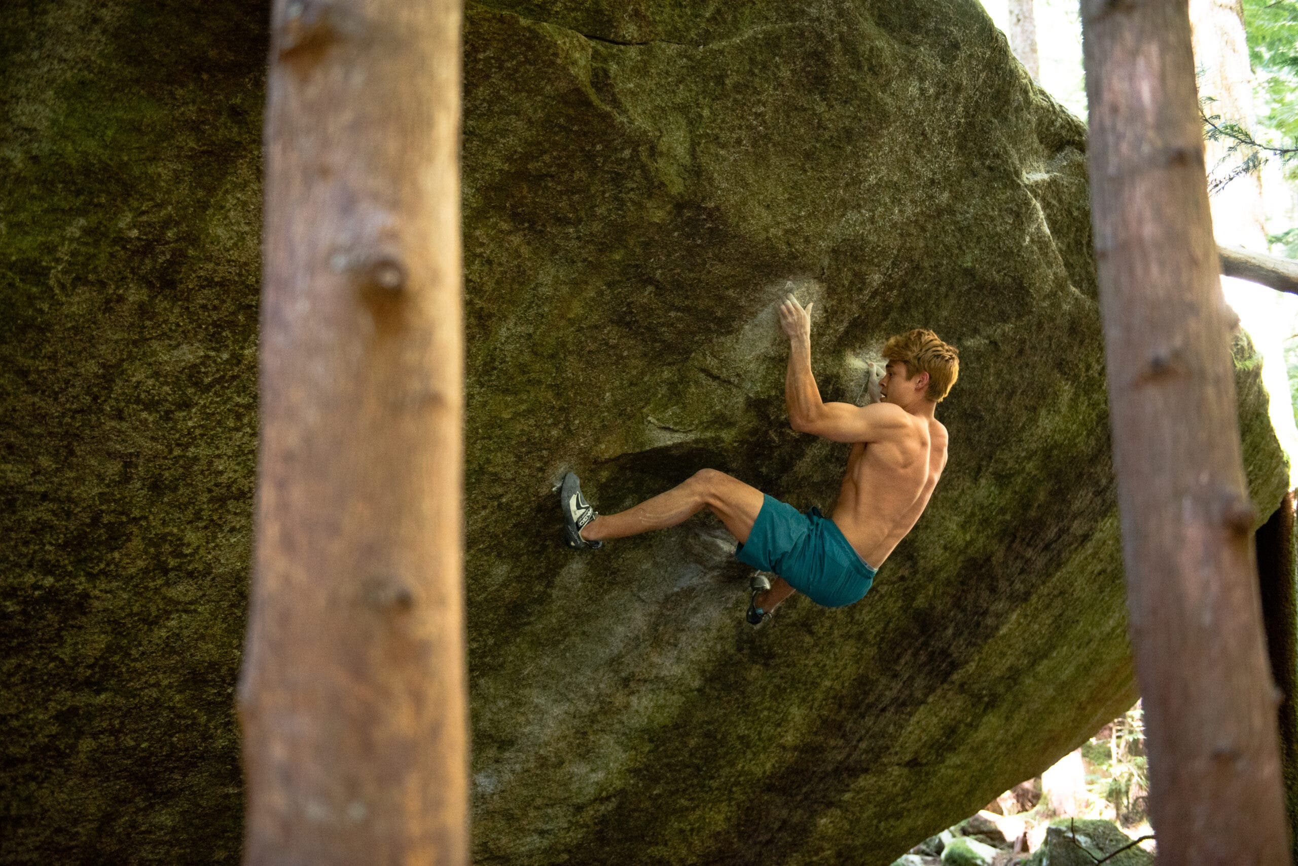 Uchida flashing "Shelter," in Squamish. He's got his left hand on an undercling and is looking down at his left toe. His next move is a dyno up and right.