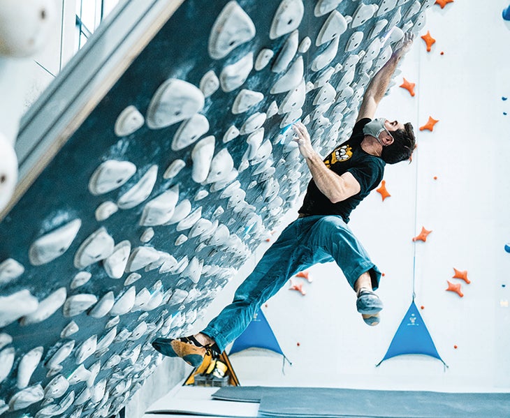Climber training in indoor climbing gym.