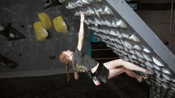 Climber doing inside flag move.