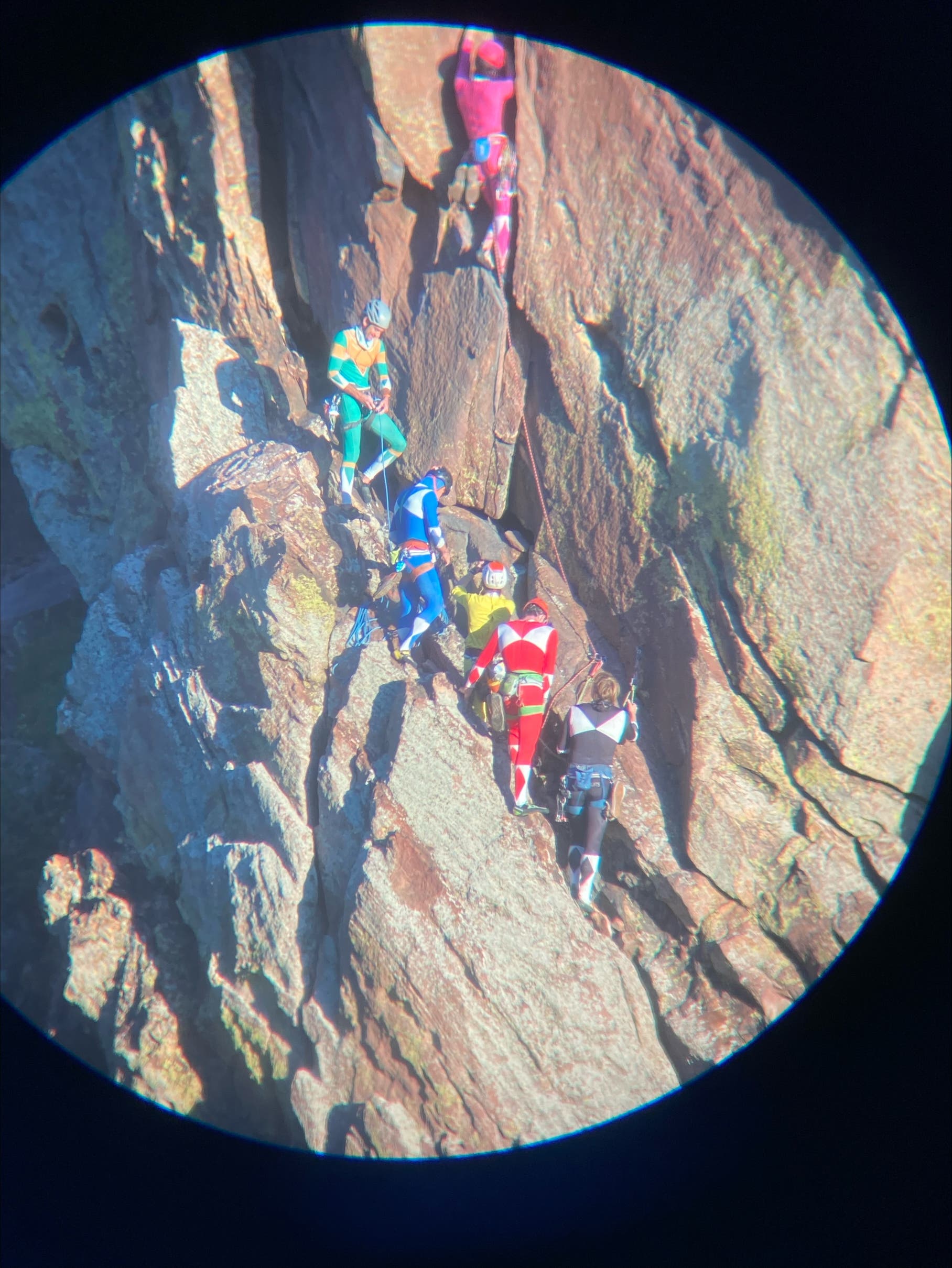 Climbers dressed up like Power Rangers climbing in Eldorado Springs Canyon, Colorado.