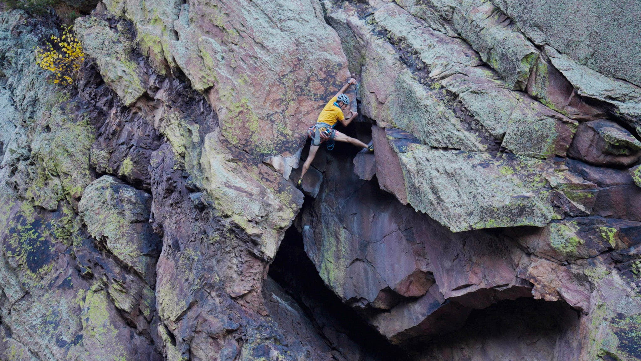 Rock climber on Naked Edge rock climb in Eldorado Springs Canyon, Colorado.