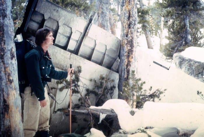 Climber next to wing of crashed Yosemite dope airplane.