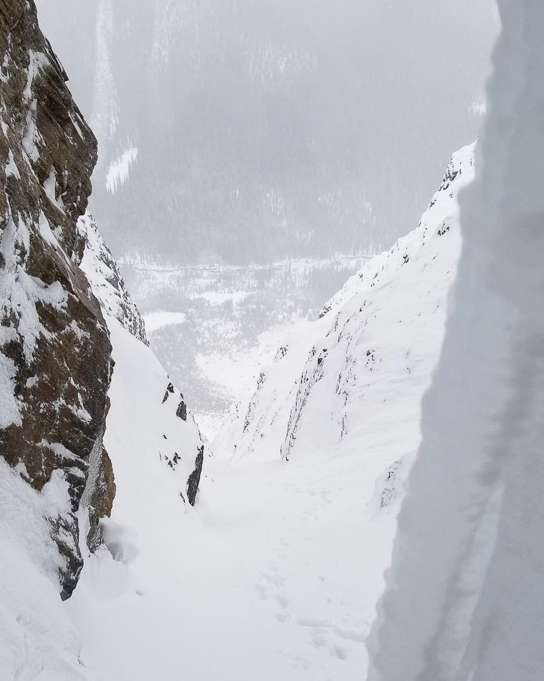 Looking down a long snow couloir.