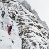 Man free soloes a moderate ice climbing pitch.