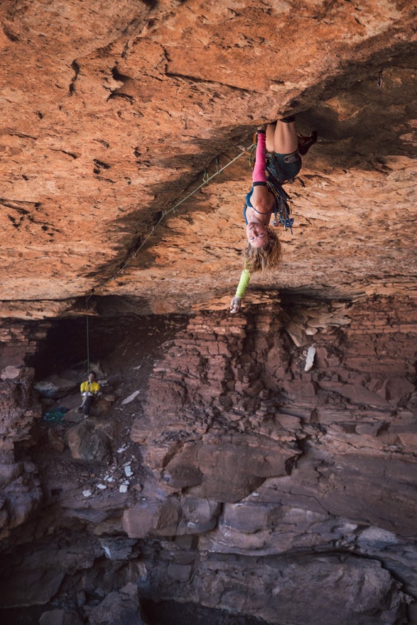 Mary Eden rests on a knee bar after the redpoint crux.