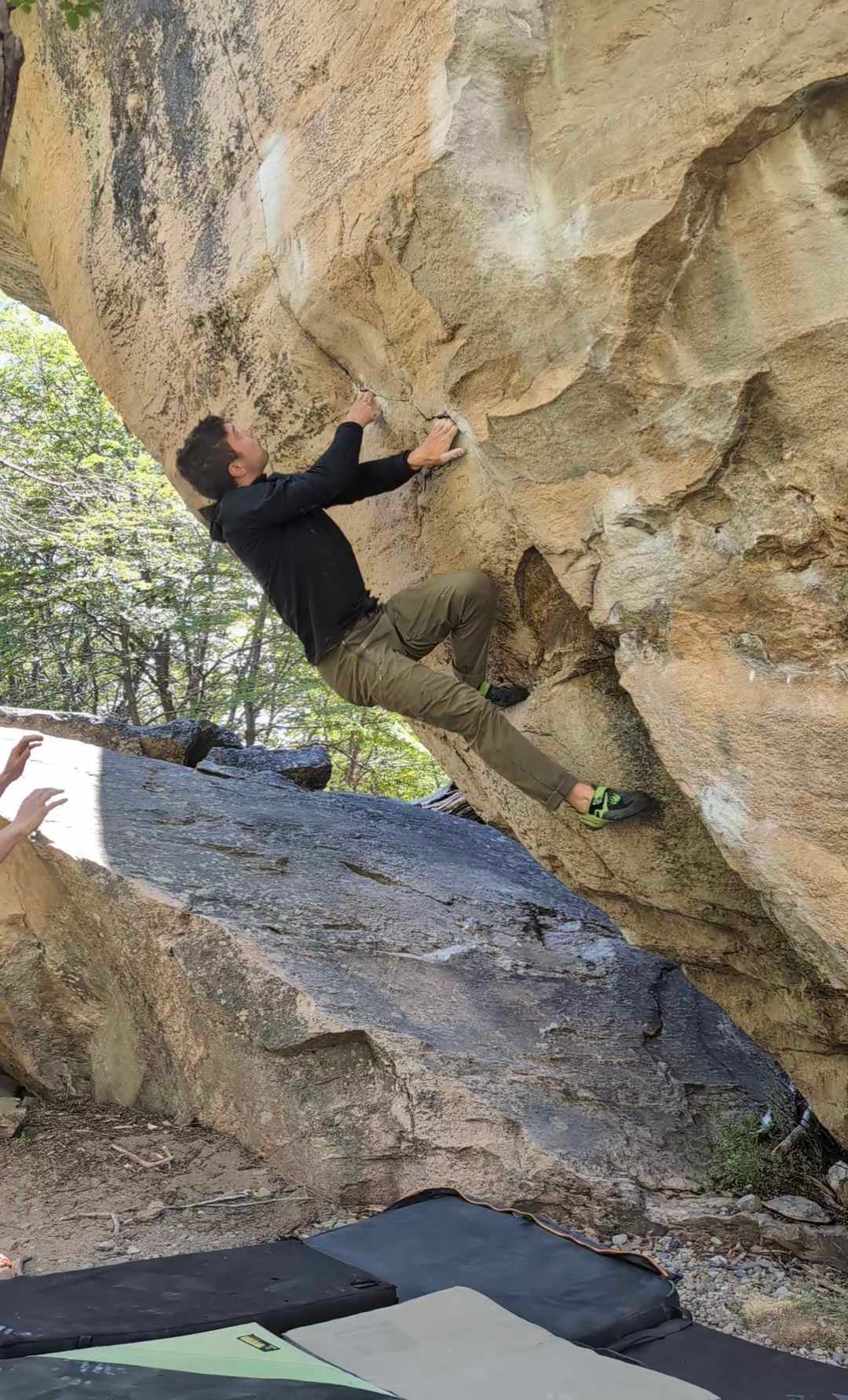 A climber wearing Skwama Vegan's on a boulder problem in Patagonia.