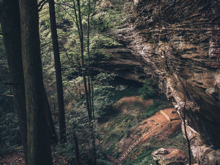 Secluded cliff in forest with no people in sight.