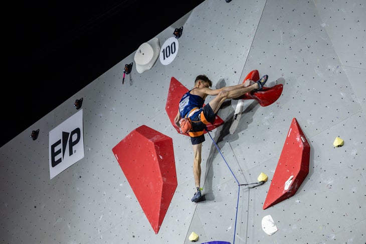 Toby Roberts high on the lead wall, about to take gold.