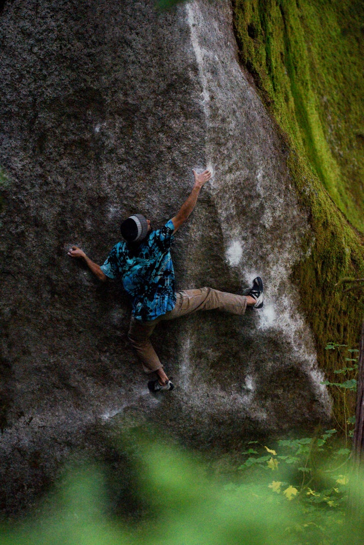 Ethan Salvo on the upper moves of The Megg, wearing a blue and black tie-dye t-shirt.