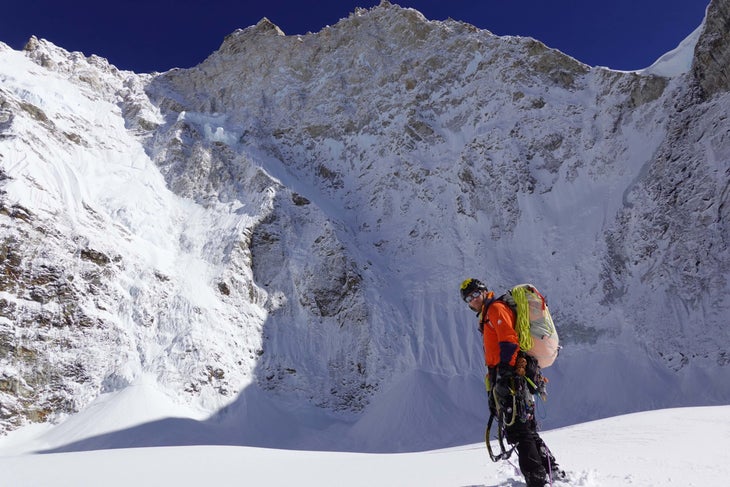 Alan Rousseau on the glacial plateau beneath Jannu's immense North Face. The team climbed a long 5.8 rock rib and vertical seracs to get to this point.