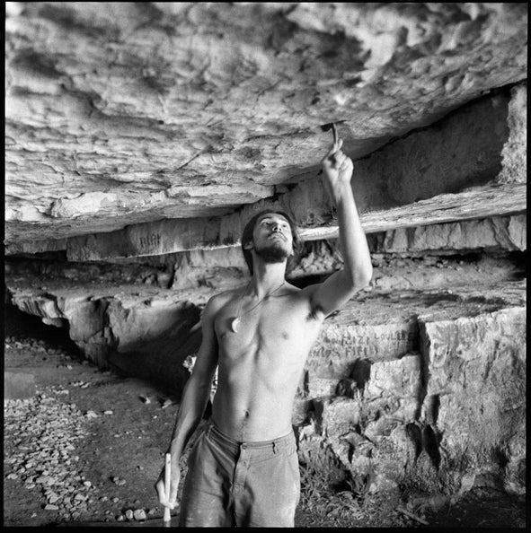 Charles Albert brushes holds on a new V17 boulder.