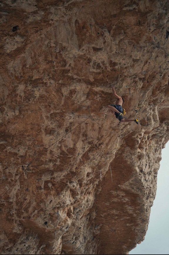 Cameron Horst climbs limestone cave, cutting his feet.