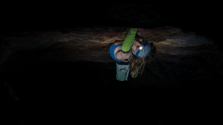Mary Eden on the lower section of Black Mamba, climbing in the dark with a headlamp.