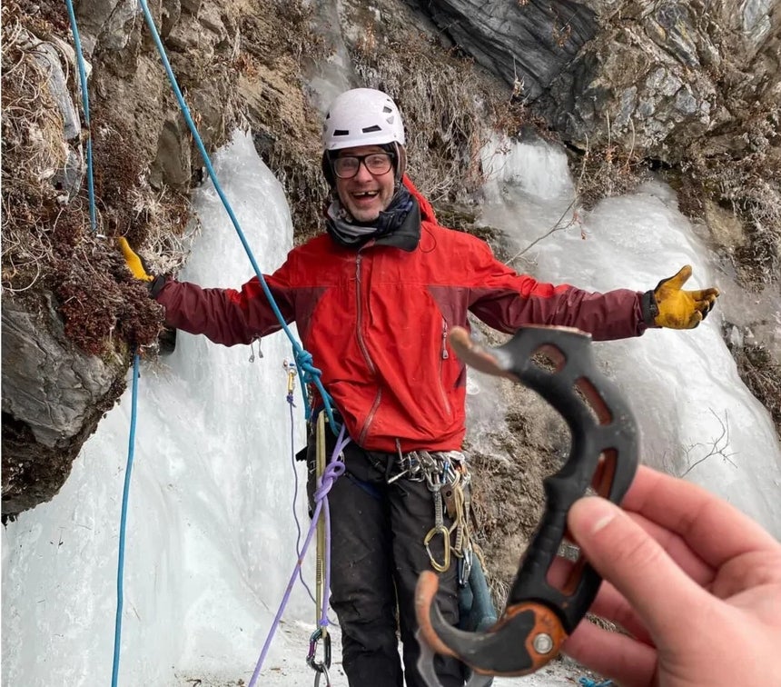 Travis McAlpine smiles with a broken tooth at the bottom of a mixed climb in Alaska.