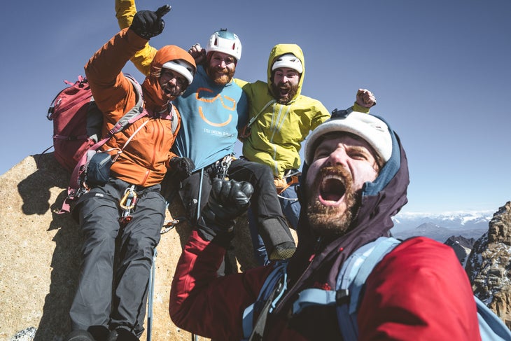 (Left to right) Nicolas Favresse, Siebe Vanhee, Sean Villanueva-O’Driscoll, and Drew Smith all smiles on the summit of Torre Central, Patagonia.